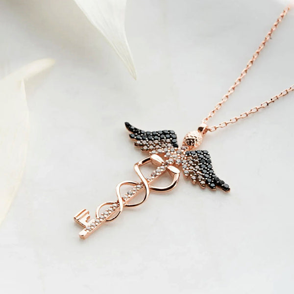 Necklace with angel wing and heart pendant on a white background