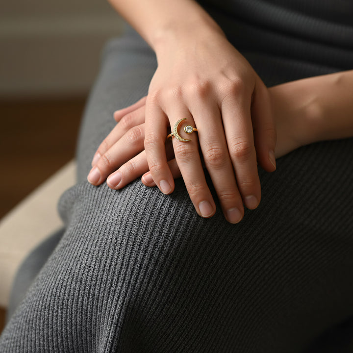 Close-up of hands with a ring on a textured surface