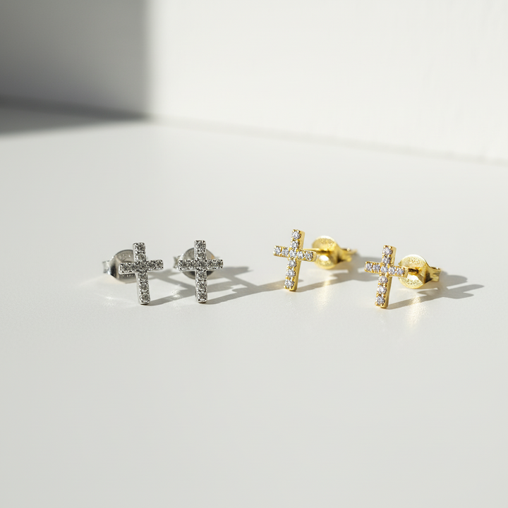 Pair of cross-shaped earrings on a light gray background