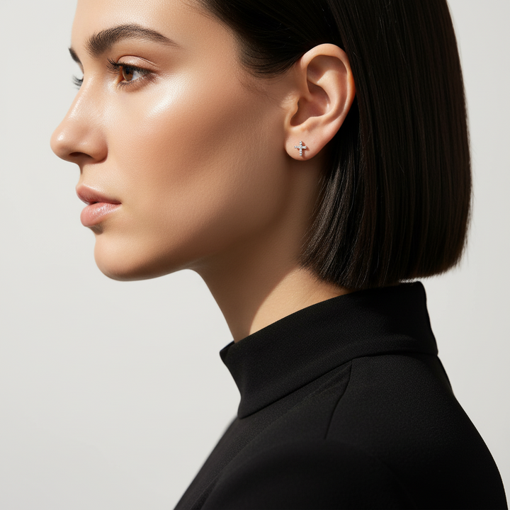 Side profile of a woman wearing silver cross stud earrings