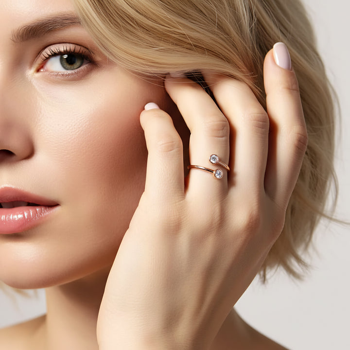 Close-up of a woman wearing two diamond rings on her fingers.