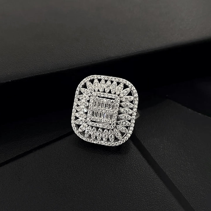 Silver ring with diamond accents on a black background