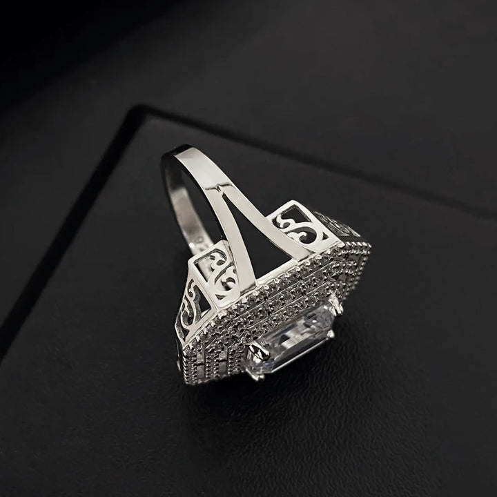 Silver ring with numbers on a black background