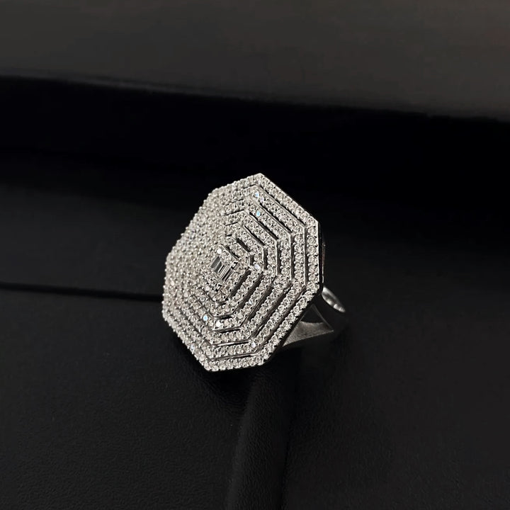 Silver ring with geometric design on a black background