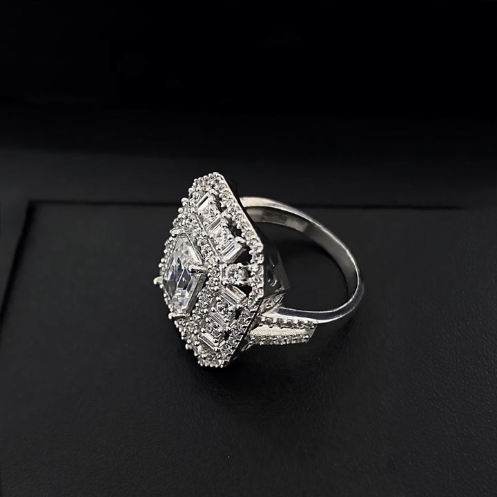 Silver ring with diamond-like stones on a black background