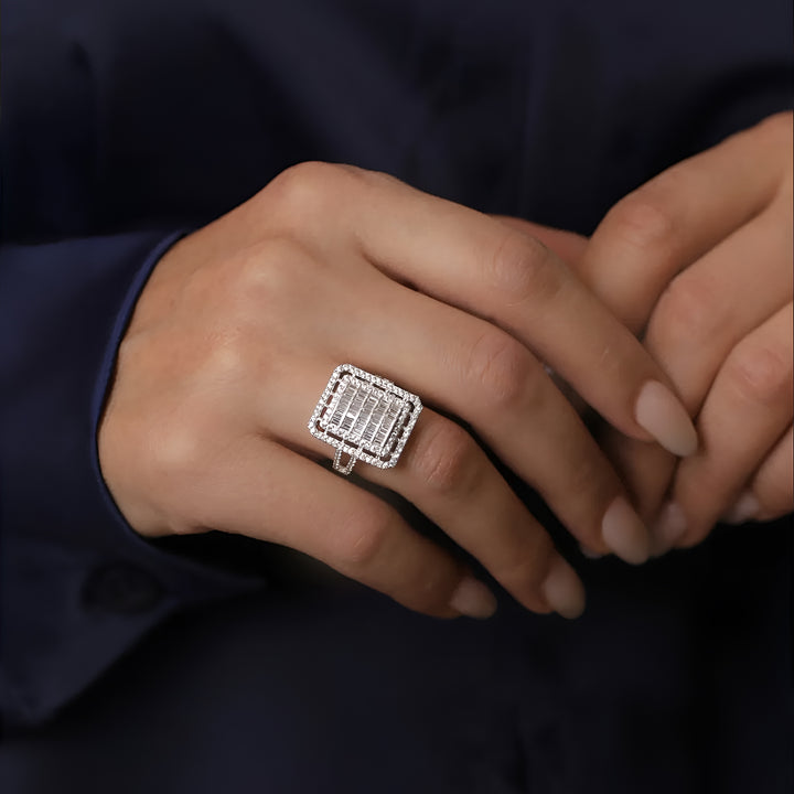 Close-up of a hand wearing a diamond ring with a dark background