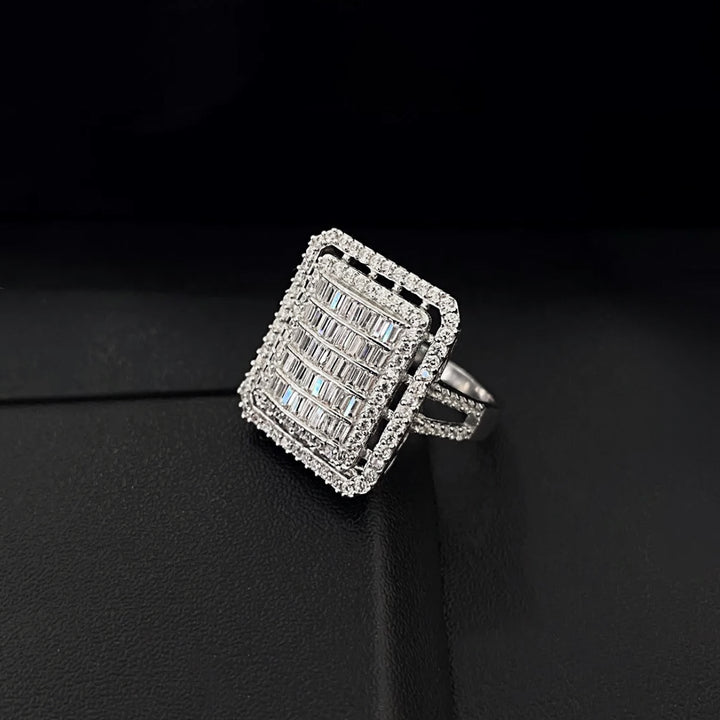 Silver ring with diamond accents on a black background