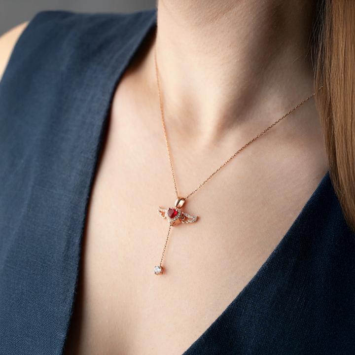 Necklace with a pendant worn by a person against a dark blue background