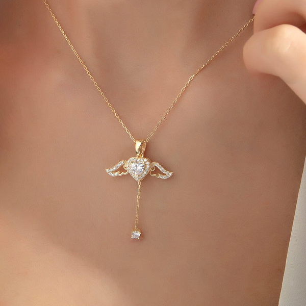 Gold necklace with a heart-shaped pendant and diamond on a blurred background
