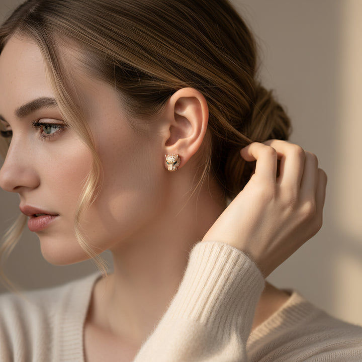 Woman adjusting an earring with a neutral background