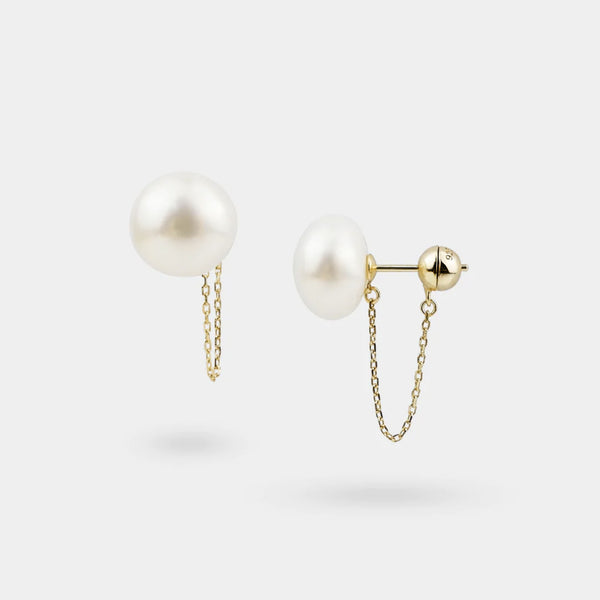 Pearl earrings with gold chains on a white background
