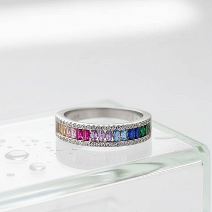 Silver ring with colorful gemstones on a white background