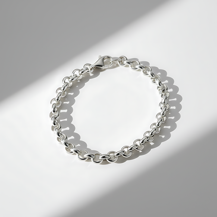 Silver chain bracelet on a light gray background